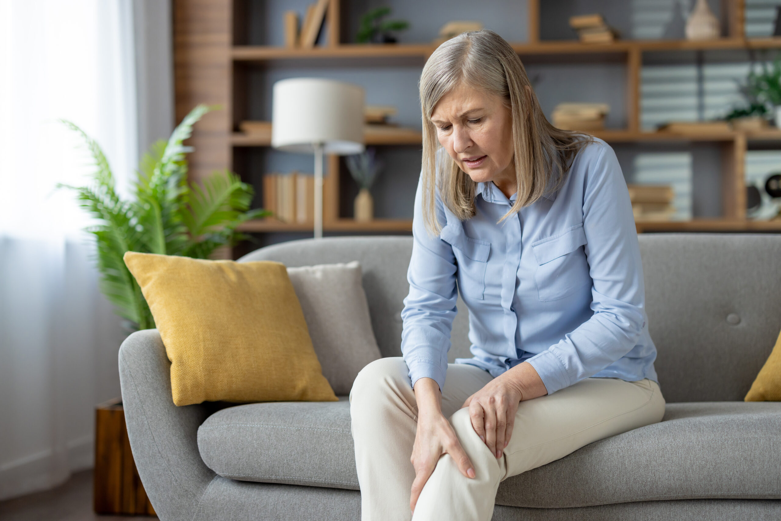 Person experiencing arthritis joint pain needing chiropractic treatment in Costa Mesa