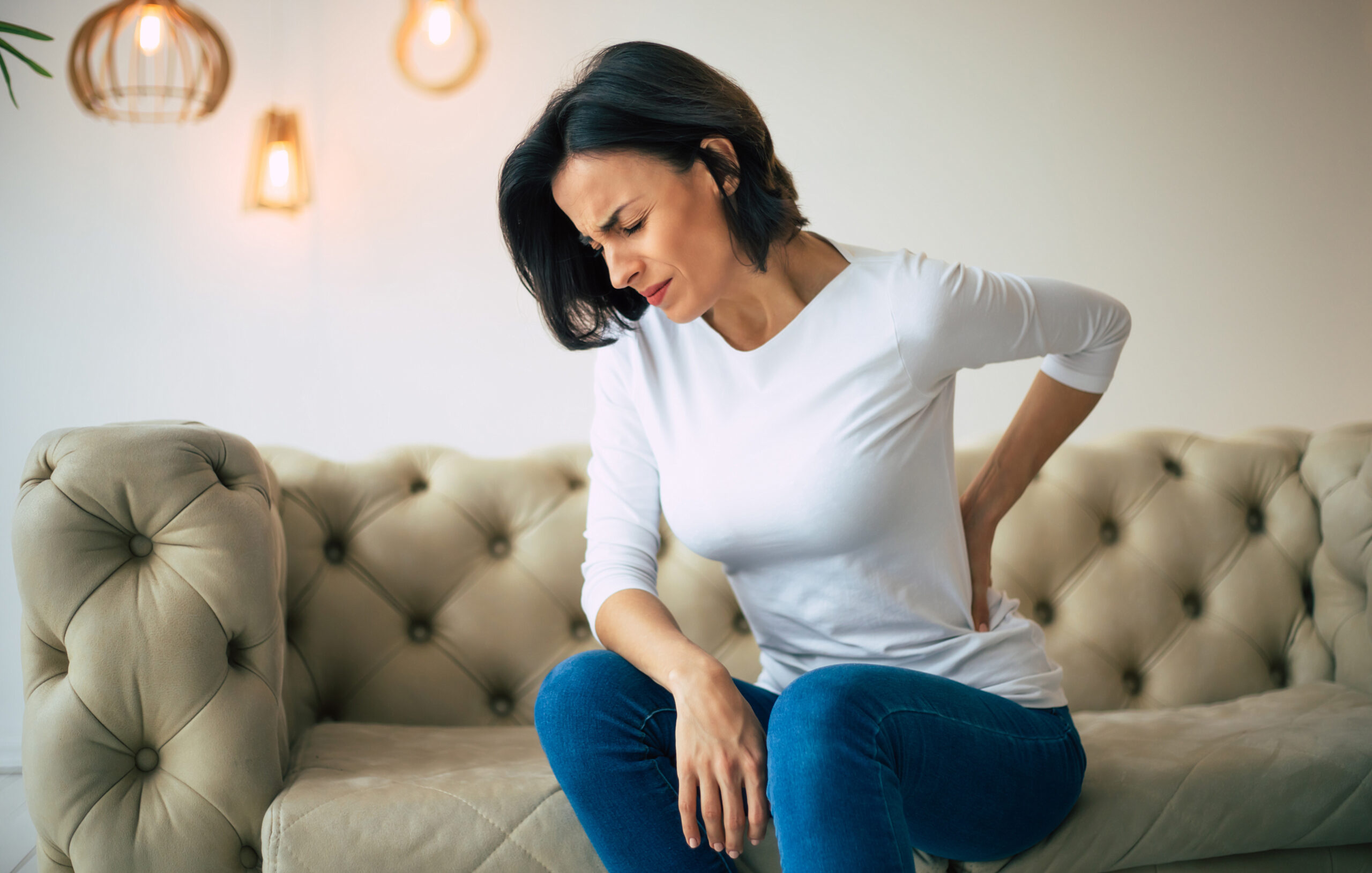 Person with chronic back pain requiring comprehensive treatment in Costa Mesa chiropractic clinic
