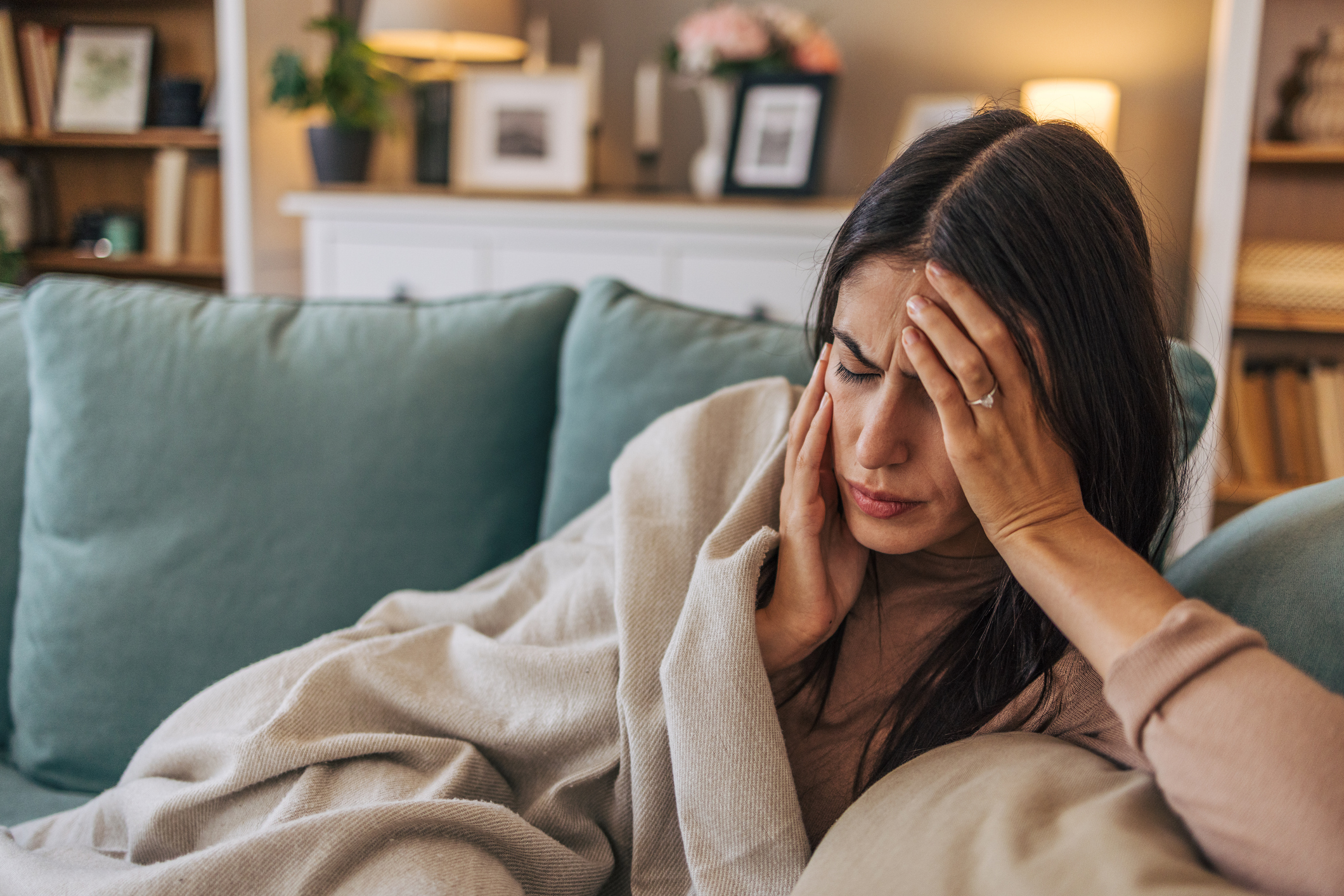 Person suffering from headache migraine pain needing treatment in Costa Mesa chiropractic clinic
