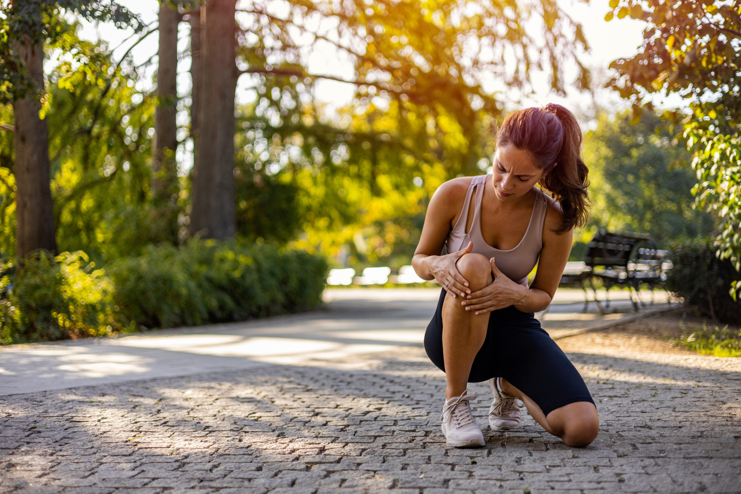 Person with knee pain needing chiropractic treatment in Costa Mesa clinic