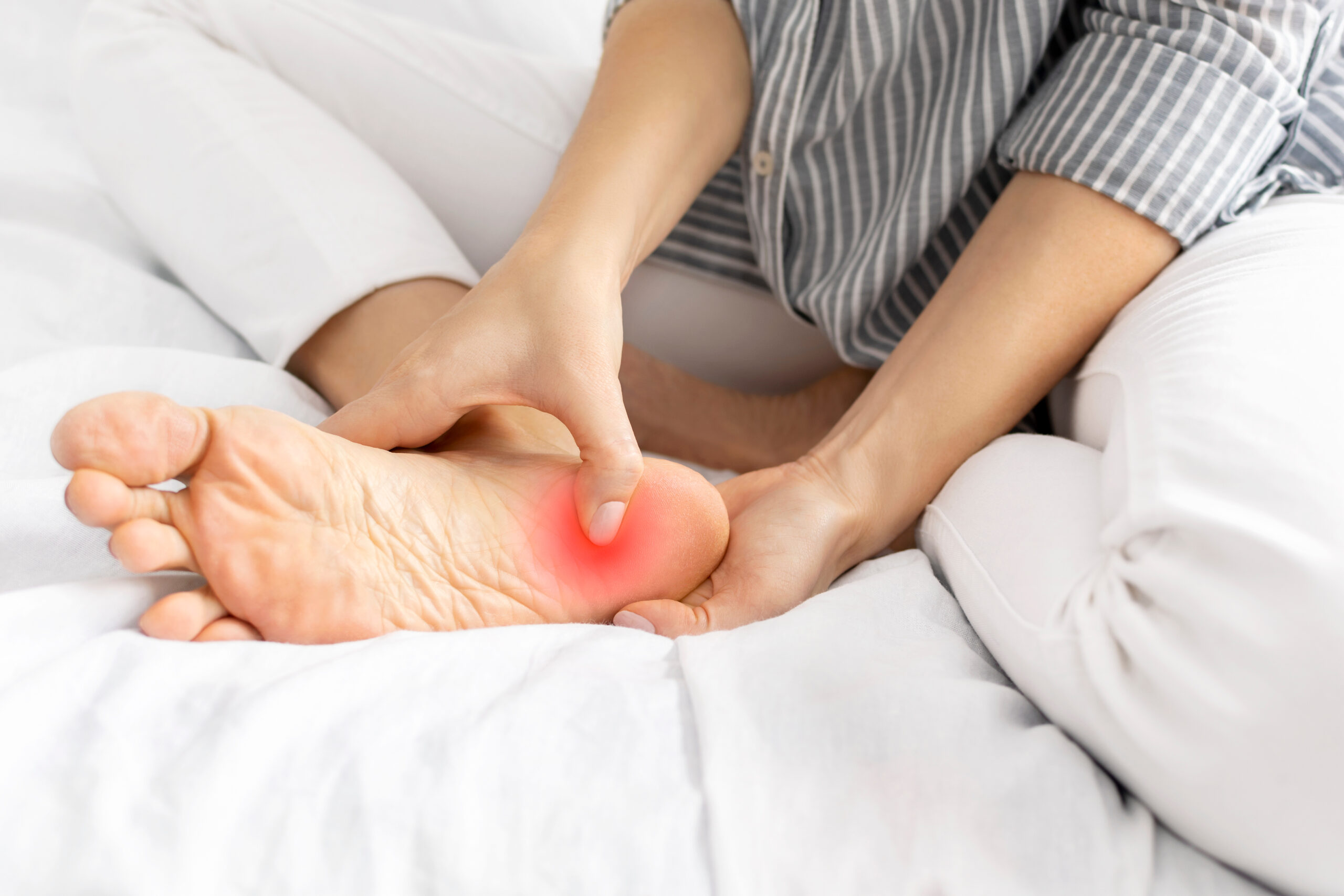 Person with plantar fasciitis foot pain needing specialized treatment in Costa Mesa
