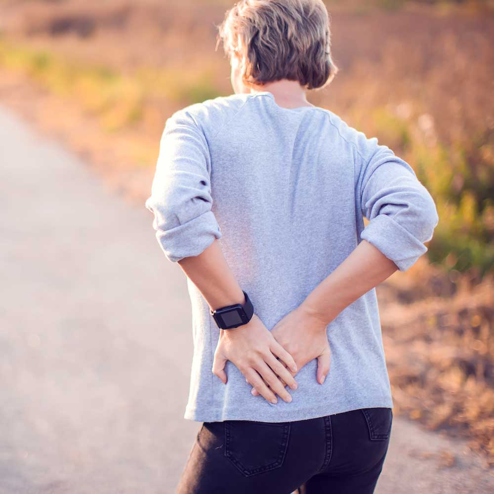 Person with hip pain needing specialized chiropractic treatment in Costa Mesa